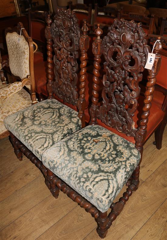 A pair of 19th century Flemish style carved walnut dining chairs